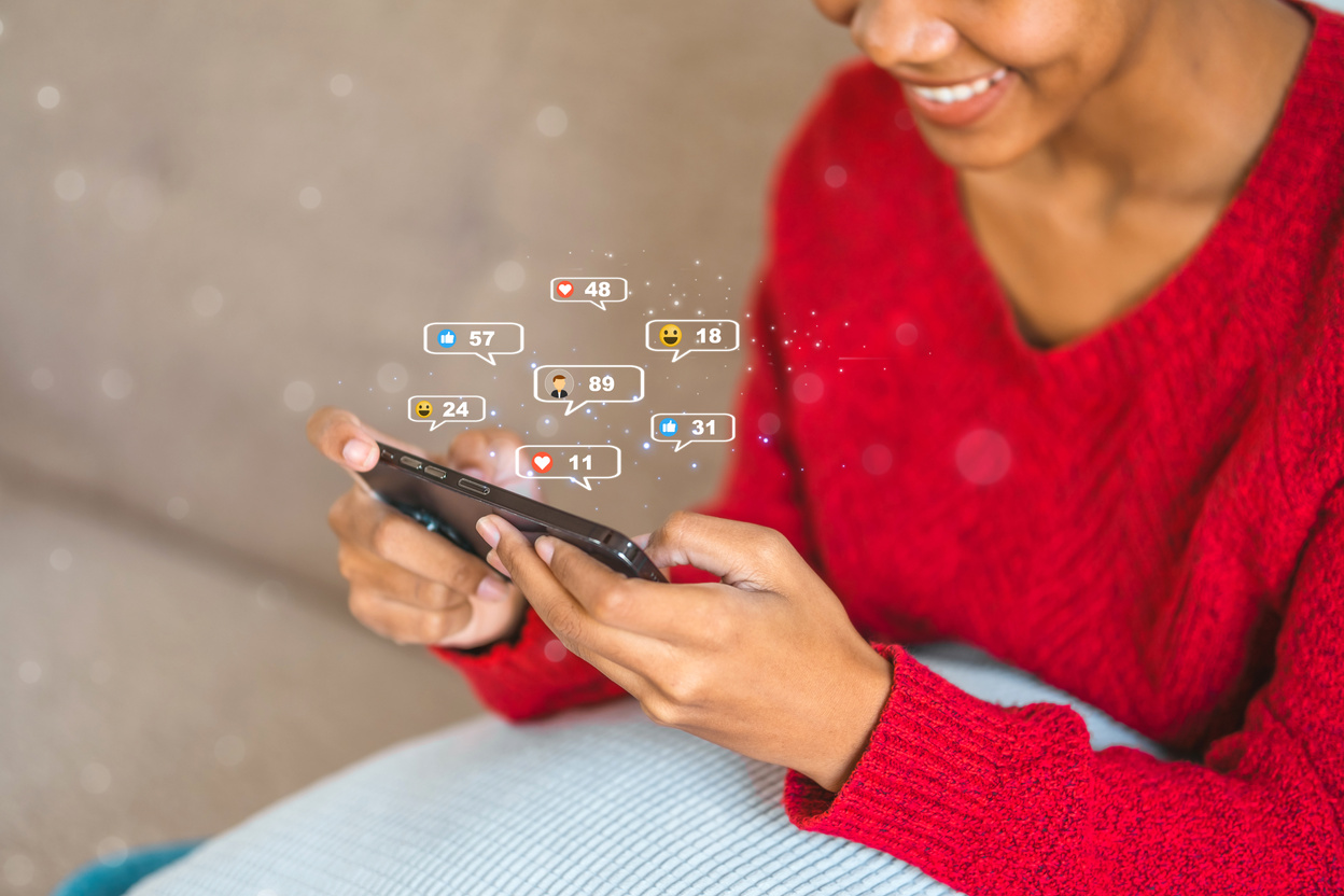 African American teenage woman using a smartphone with Icon communication network social media network pop notification  concept.